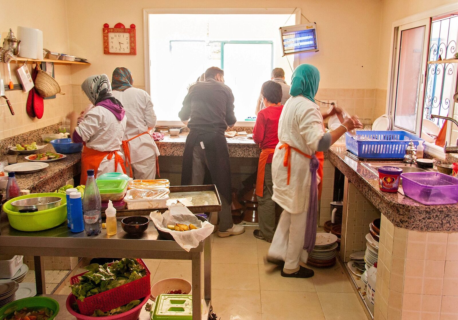 Culinary trainees preparing food with their chef